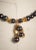 A sexy beaded necklace of 8-9mm black Tahitian pearls with 22K gold wire-work end caps among the pearls. The center...