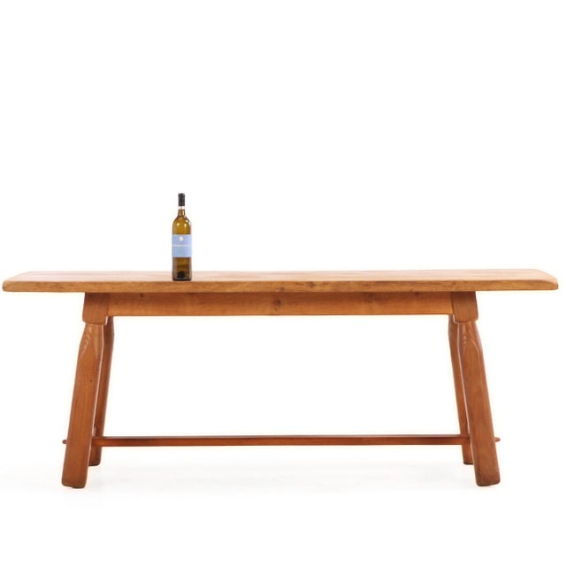 A striking French Brutalist style dining table crafted in solid oak, dating to circa 1950. The table features a...
