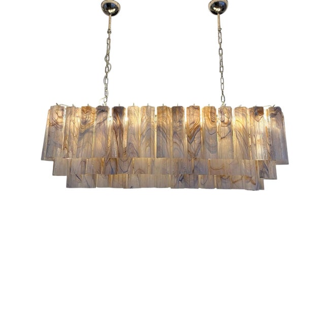 Contemporary Italian chandelier crafted with elongated pink Murano glass rods and a polished chrome structure....