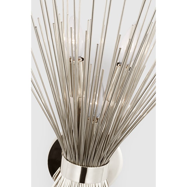 Description: The Strada series by Kelly Wearstler features delicate sculptures of radiating quills that cast a striated...