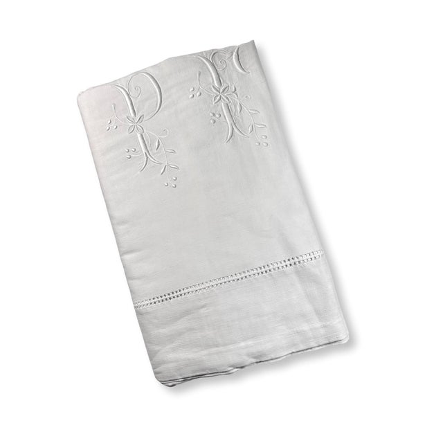 A beautiful antique French linen sheet dating to circa 1920, featuring an elegant oversized PF monogram embroidered in...