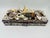 This is a vintage decorative shell-covered box featuring a rectangular wooden base adorned with an assortment of natural...