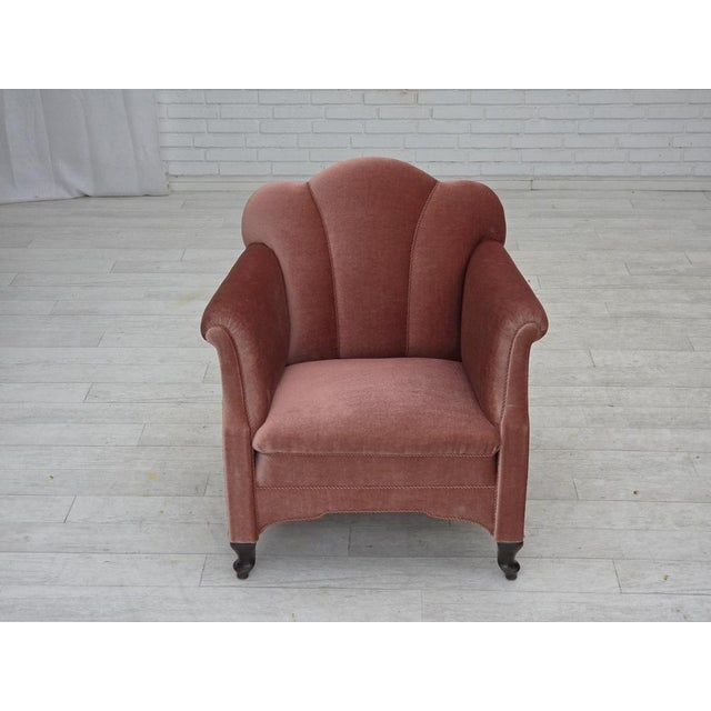 1950s, Danish armchair. Salmon pink furniture velour, oak wood legs, brass springs in the seat. Chair was reupholstered by...