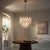 Bronze Aloadecor 24'' Wide Vintage Mid-Century Modern Chandelier 4-Light 4-Tier White Art Glass Pendant With Antique Bronze Finish For Sale - Image 8 of 9