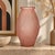 This pressed-molded, powder pink glass vase is a beautiful example of Art Deco aesthetics, with its strong geometric lines...