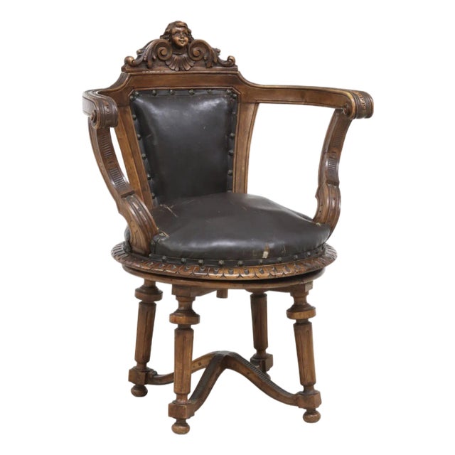 19th Century French Walnut Swivel Chair: Figural Crest & Organic Movement For Sale
