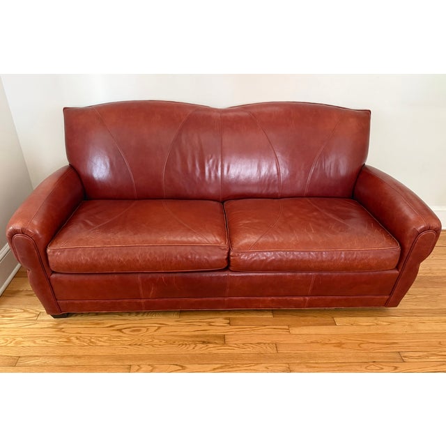 A rich vintage distressed Art Deco cognac red leather sofa, in the style of Ralph Lauren. A fine constructed worn leather...