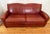 A rich vintage distressed Art Deco cognac red leather sofa, in the style of Ralph Lauren. A fine constructed worn leather...