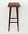 Solid elm bar stool in mahogany color. Square seat with rounded corners, legs connected by four bars. Model created in...