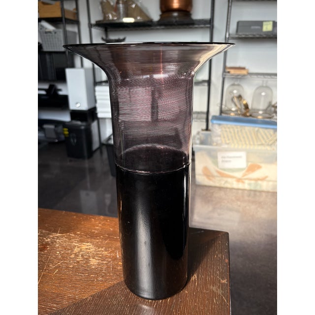 A signed Venini Murano vase in deep aubergine with flared lip and intricate details. Signed on the bottom.