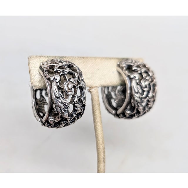 1970s silvertone openwork leaf motif hinged hoop clip earrings. Marked "Napier©" in script. Measure: 1 1/8 inches long by...