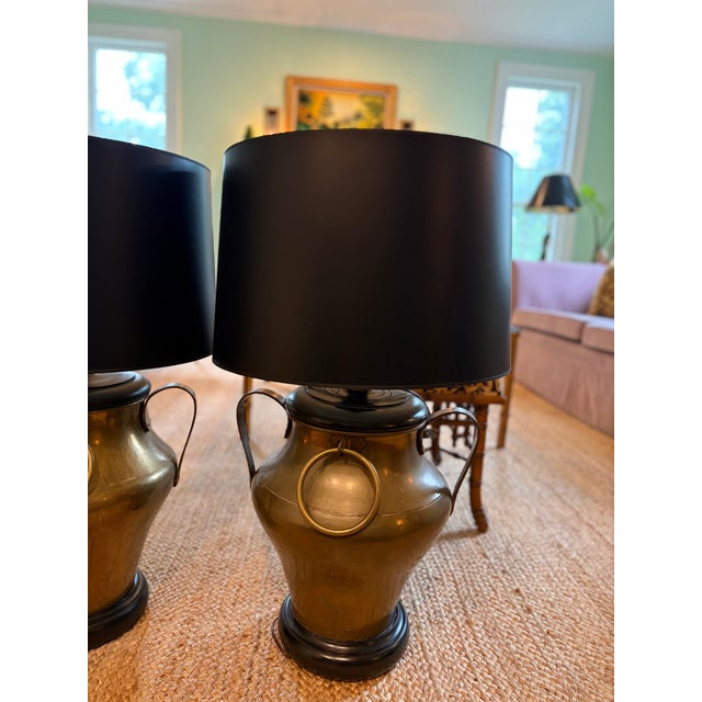 A stunning pair of brass table lamps with black lampshades, the perfect statement for a side table or a console table.