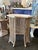 Charming vintage faux bamboo wicker side table featuring an airy open spindle base, turned feet, and a removable inset...