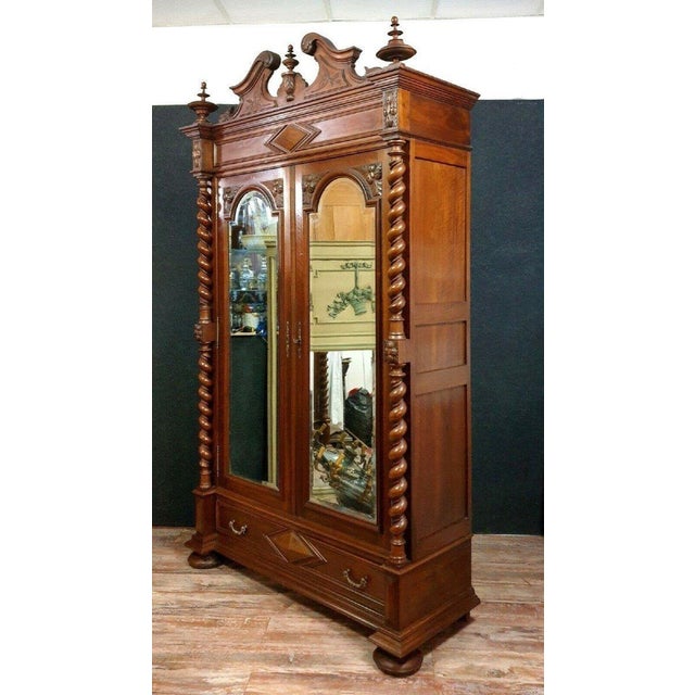 Renaissance hunting lodge bookcase in solid walnut Front opening with two glazed and paneled doors and a drawer Decorated...