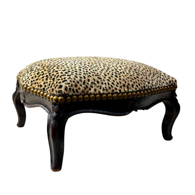A charming late 18th century French carved wood footstool with a beautifully shaped frame and cabriole legs. The dark wood...