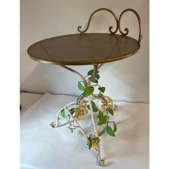 Love this Italian tole table with flowers and leaves and gold top. It could even be used as a small vanity stool.
