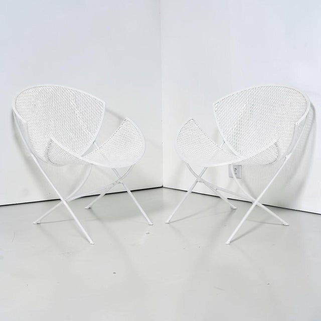 Fabulous pair of vintage 1950s orange slice patio chairs. Made of wrought iron with original white paint, these chairs are...