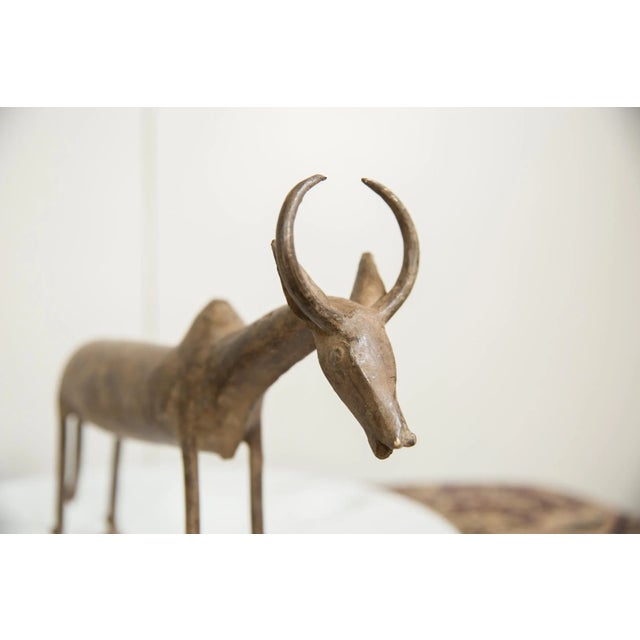 :: Vintage handmade African bronze wildebeest. Circa mid 20th century and possibly older, each figure in this collection...