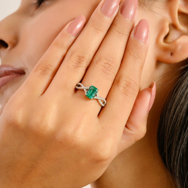 Crafted in luminous 14k white gold, this elegant ring features a vibrant 1.09 carat emerald-cut green emerald as its...