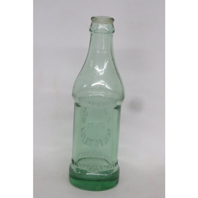 This Coca Cola Bottle was made by the J.S. Francis Bottling Company in the 1920s. Featuring a gorgeous green toned glass,...