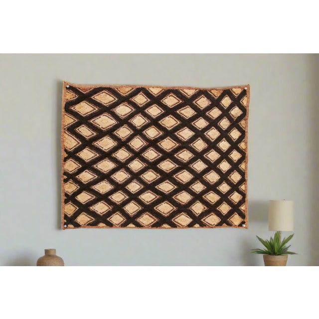 A captivating masterpiece of African textile art, this vintage Kuba cloth panel is a testament to the unparalleled...
