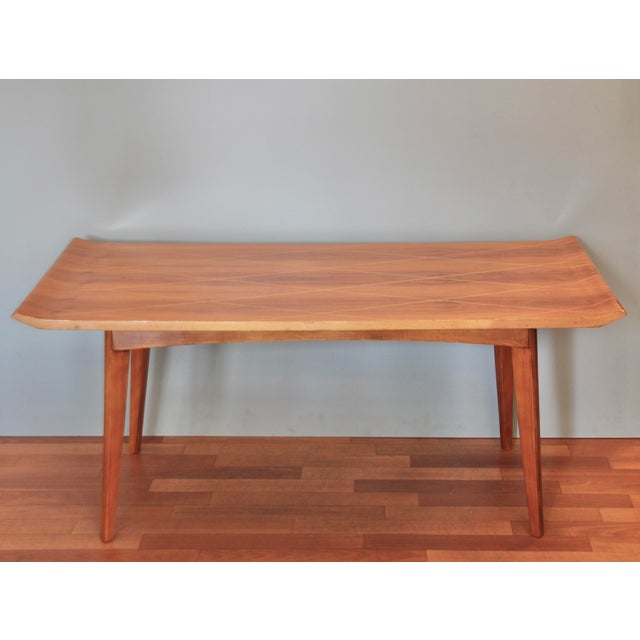 This midcentury side table/coffee table was designed in the 1950s and is in very good condition. The body is solid beech...