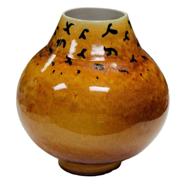 A Raymor 1950's Italian Modern art pottery vase with a distinctive bright amber glaze accented by abstract black glaze...