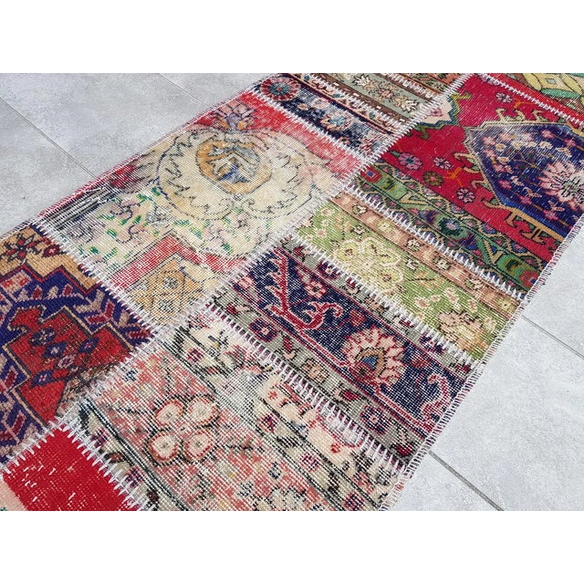 This is a vintage Turkish Oushak rug from the Mid 20th Century. The piece was hand-knotted.