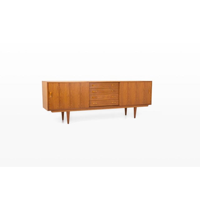 Elegant danish vintage sideboard produced by clausen & son in the 1960s. Crafted in warm teak wood, this piece features...