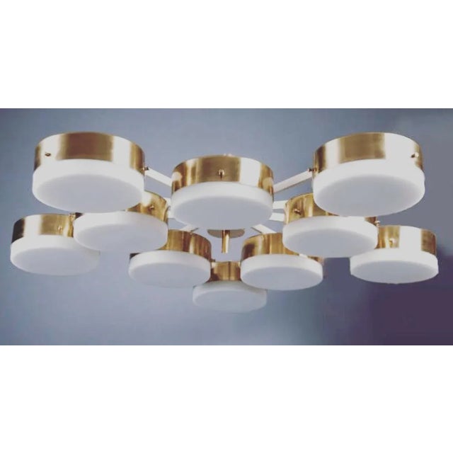 This elegant, iconic brass and opaline lamp is inspired by Italian mid-century design. It is handmade in Italy out of...