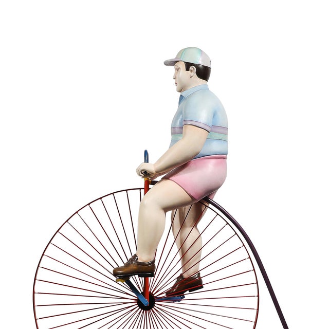 This playful and whimsical sculpture by renowned Mexican artist Sergio Bustamante depicts a boy riding a high bicycle,...