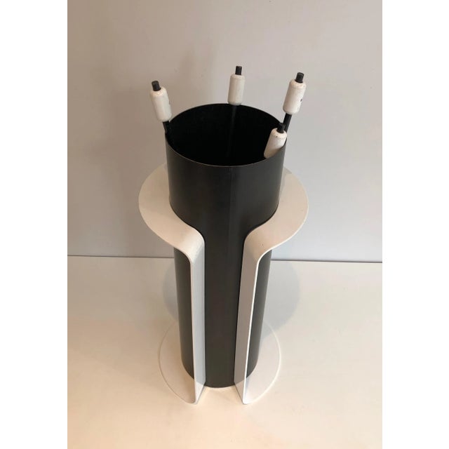 This design fire place tools on stand are made of black and white lacquered metal. This is a French work, circa 1980.