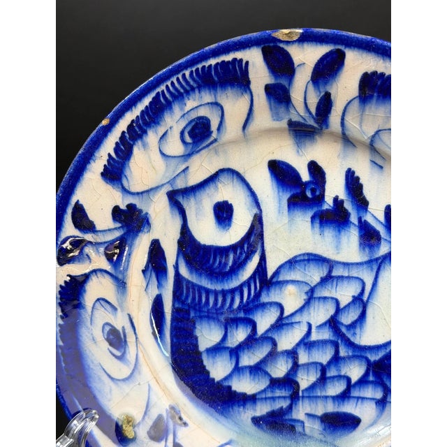 Antique blue and white pottery plate dating to the late 18th – early 19th century. The dish features hand-painted cobalt...