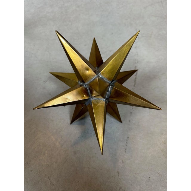 A set of three geometric figures, consisting of mathematical shapes (triangles and pentagonal pyramids) that together form...