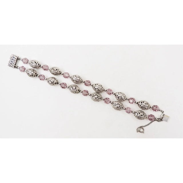 This is part of Chairish’s Costume Jewelry assortment. 1950s silvertone openwork beads and faceted faux-amethyst beads...