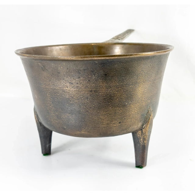 We are selling this nice primitive cast bronze Posnet cooking pot with long handle with decoration and tripod legs,...