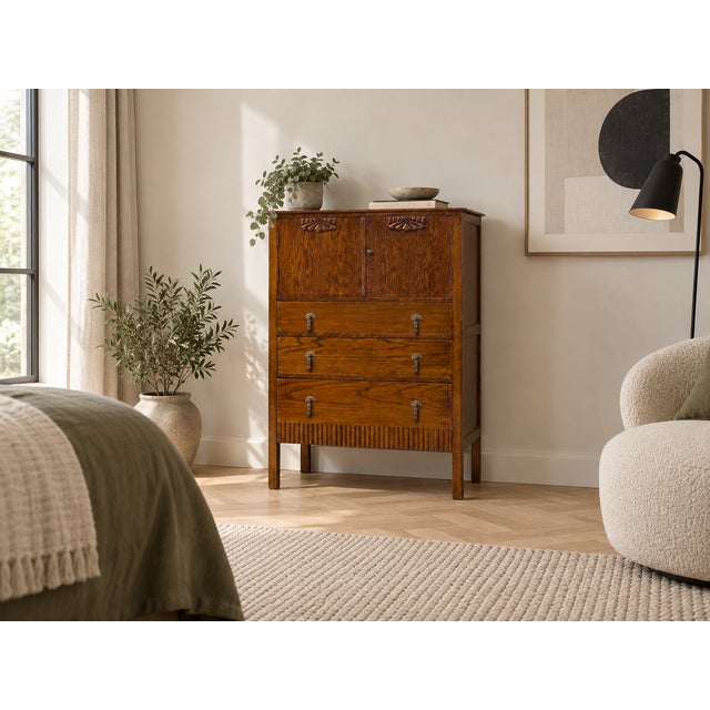 Featuring two upper cupboard doors with decorative carved detailing, three spacious drawers with original drop handles, a...