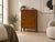 Featuring two upper cupboard doors with decorative carved detailing, three spacious drawers with original drop handles, a...