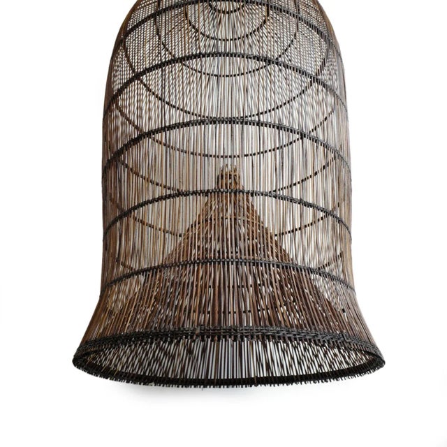 Auburn stained natural wicker lantern. Classic original fish trap basket shape. An interesting solution lighting fixture...