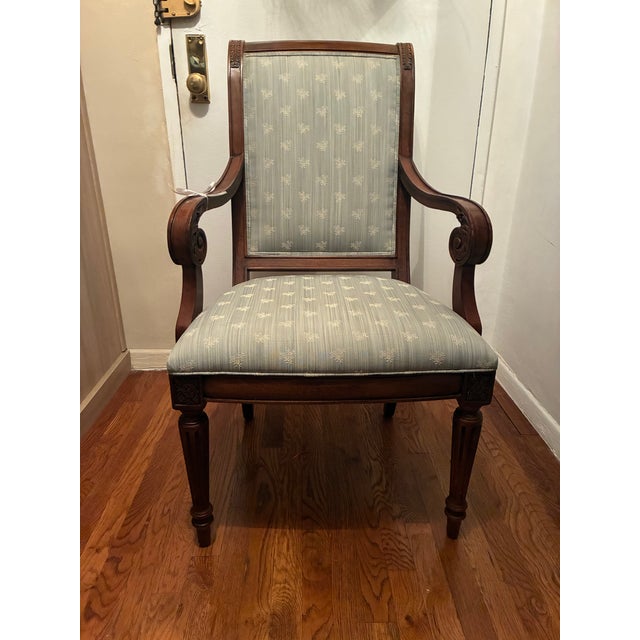Ethan Allen Townhouse dining arm chairs of quality wood with upholstered brocade fabric on the seat and back. Front legs...