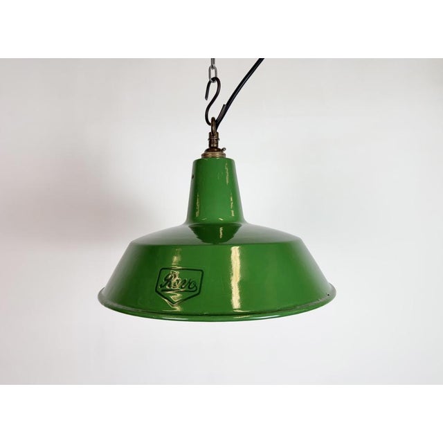 Industrial green enamel pendant light made by Revo in United Kingdom during the 1950s. White enamel inside the shade....