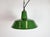 Industrial green enamel pendant light made by Revo in United Kingdom during the 1950s. White enamel inside the shade....