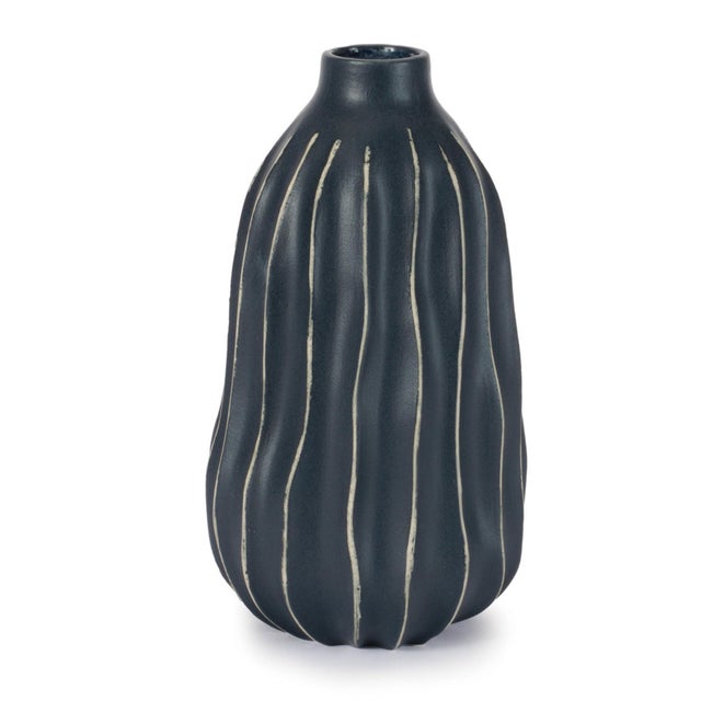 Elevate your décor with the bold, modern style of this Wavy Ribbed Stoneware Vase. Featuring a sculptural silhouette with...