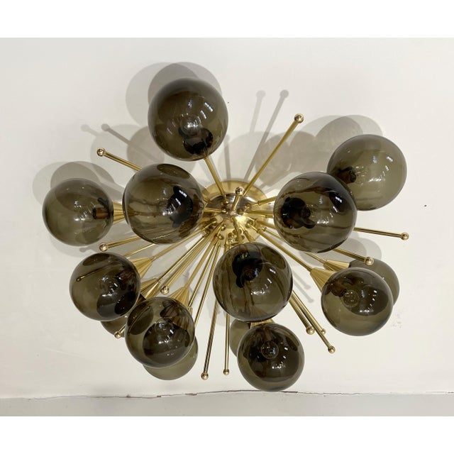 Italian sputnik flush mount with smoky Murano glass globes mounted on solid brass frame in lacquered polished brass finish...