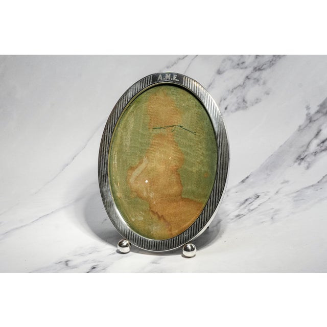 A stunning and unusually large sterling silver picture frame, this elegant piece embodies the refined craftsmanship and...