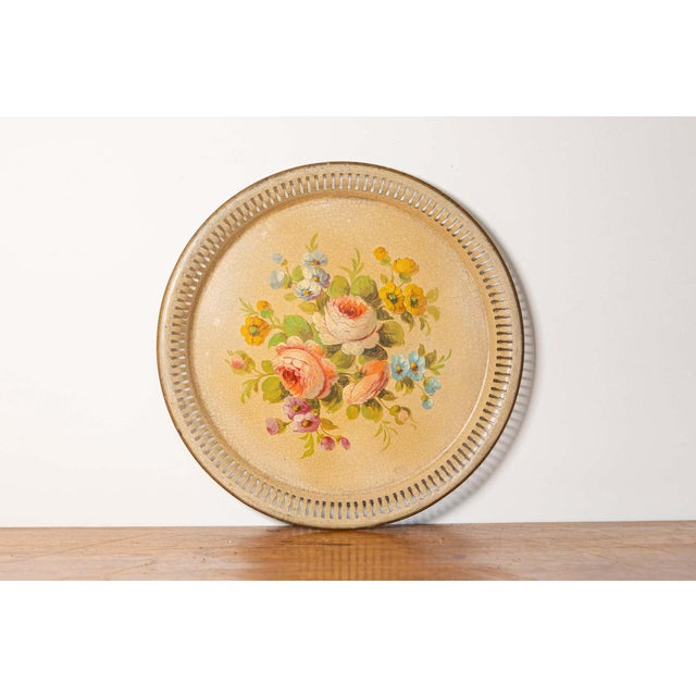 This exquisite early 20th-century painted sheet metal tray is a beautiful example of vintage decorative artistry....