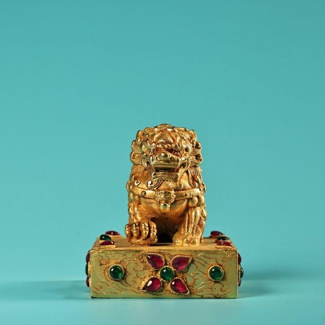 This exquisite gilt bronze seal features a finely cast guardian lion seated atop a square base. The lion is intricately...