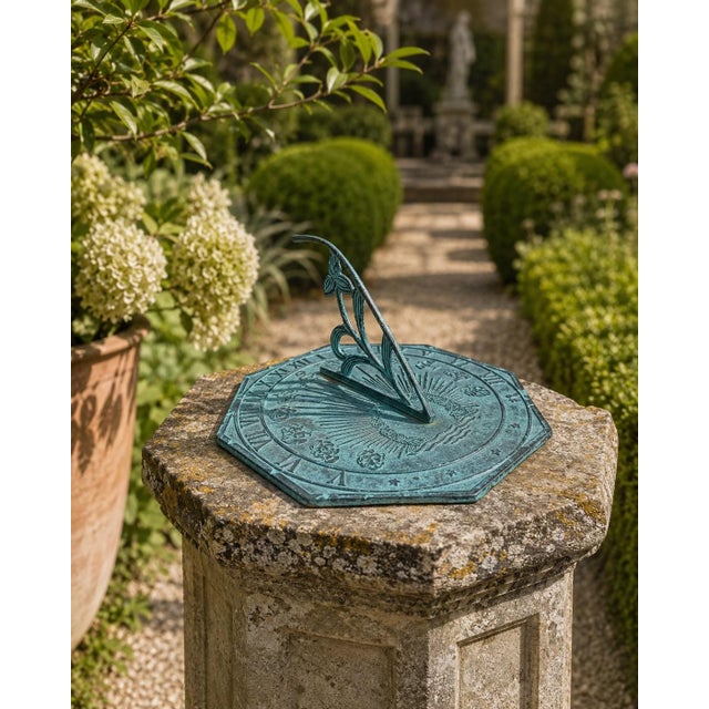 A classic octagonal verdigris iron garden sundial featuring the 12 zodiac signs, inspired by traditional English estate...