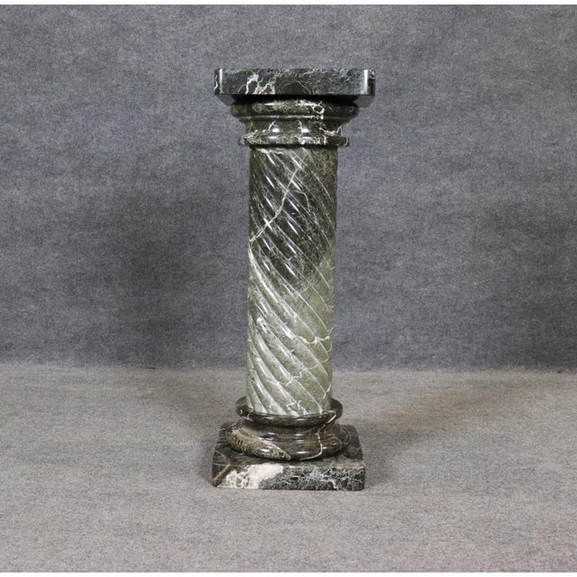 Elevate your interior with this striking green marble column pedestal, a timeless architectural accent that blends...