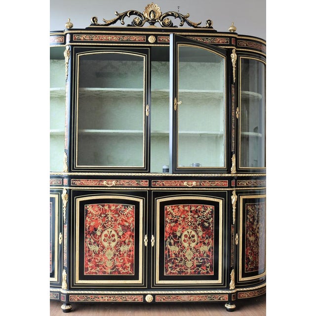 Credenza with four -door raise, inside two shelves all covered in light green damask fabric. This furniture was made...